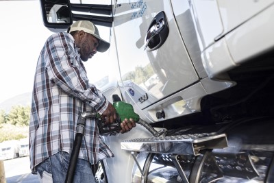 A man filling a truck with diesel gasoline
