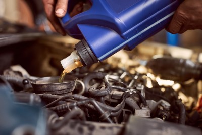 Fuel Additives being poured into a vehicle
